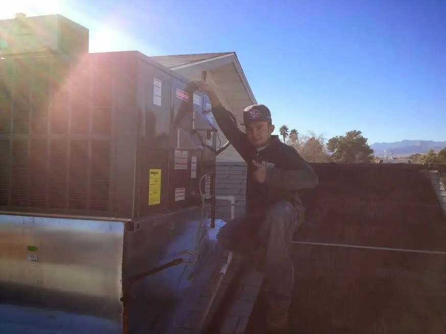 HVAC technician performing AC Tune-Up on a rooftop unit in Citrus Heights